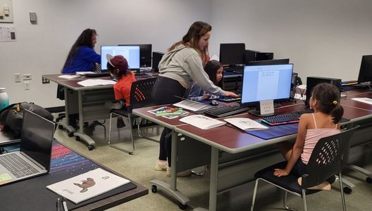 A photo of youth in northern communities in front of computers as part of the development of the world’s first Dene language keyboard.