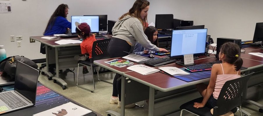 A photo of youth in northern communities in front of computers as part of the development of the world’s first Dene language keyboard.