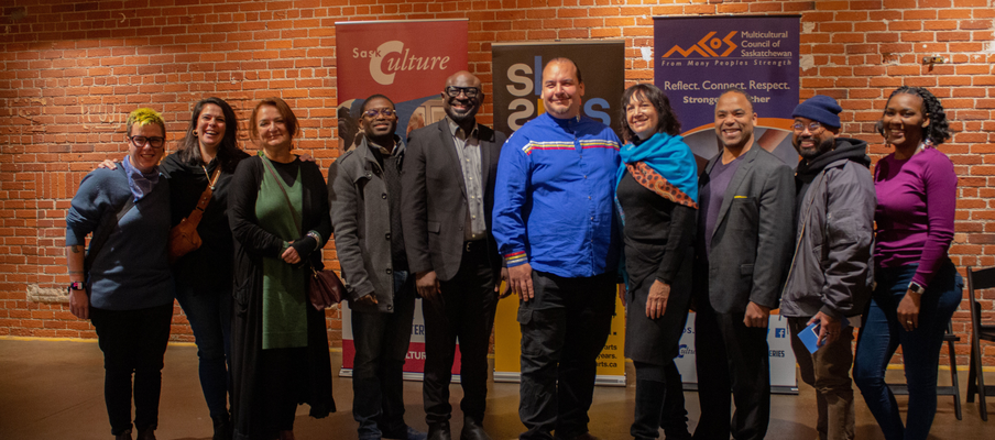 A group photo taken at the Building Arts Equity grant launch that shows staff from SaskCulture, SK Arts, the Multicultural Council of Saskatchewan, and other community partners.