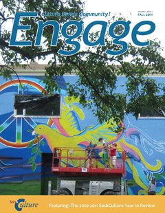 Cover of Engage Magazine Fall 2011 - Three people in a mechanical lift paint art on the side of a building.