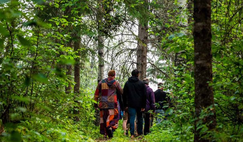 The cover of the Fall 2023 Engage issue, which has a title section that reads ""Culture Builds Community! above the Engage heading and the SaskCulture logo. The cover photo shows a group of people walking through a vibrant green forest. In the bottom of t