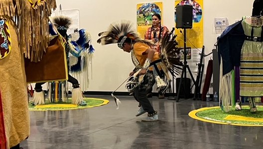 Students in the Small Fires Indigenous Mentorship Program dance Powwow.