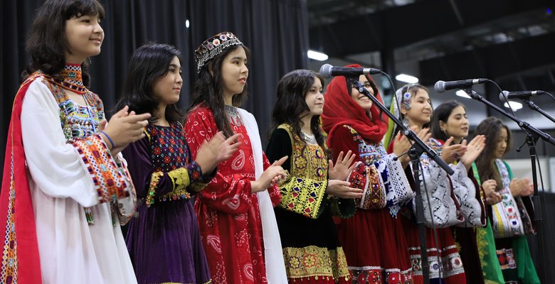 A photo of a group of young girls, members the Sound of Afghanistan music group, on a stage.
