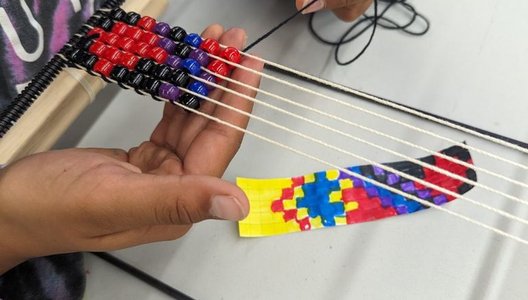 A close-up photo of someone beading.