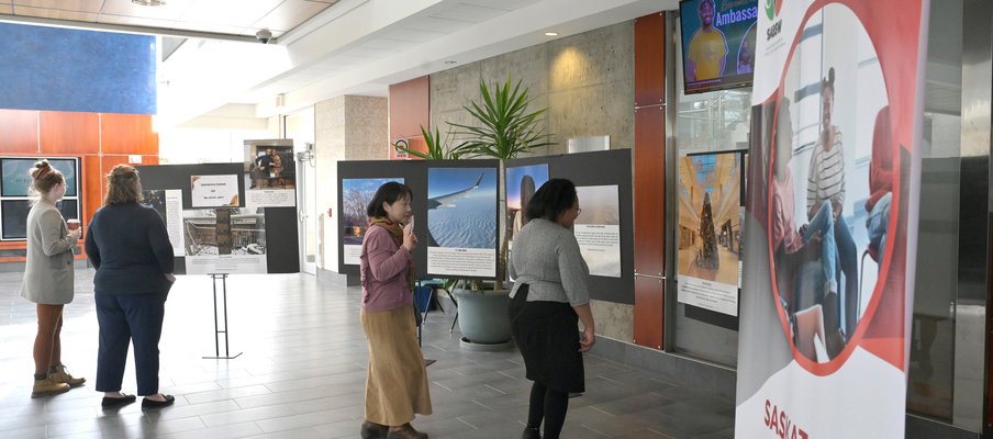 People at an exhibition looking at photographs