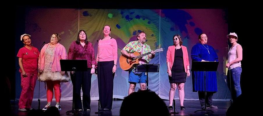 Five people perform on a stage