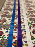 A photo of ribbon and fabric laid out on a table.