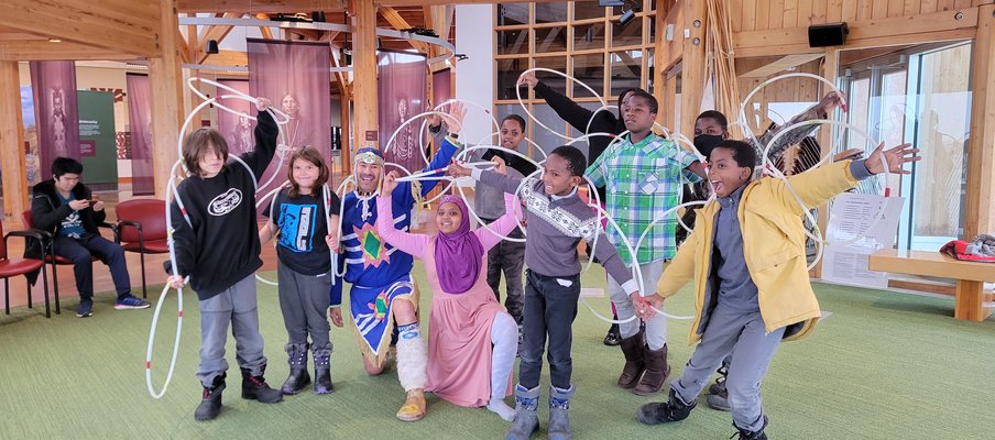 A photo of a Indigenous-Immigrants Heritage learning event, where newcomer youth learned about Indigenous traditional dances during an excursion to Wanuskewin Heritage Park.