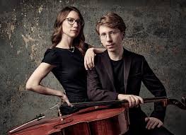 Meagan Milatz and Cameron Crozman pose in elegant concert wear, with Crozman's cello